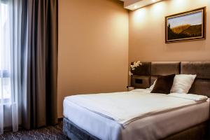 Ένα ή περισσότερα κρεβάτια σε δωμάτιο στο NEW Garni Hotel FILIA