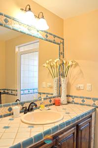 a bathroom with a sink and a mirror at Villa 14 in Puerto Peñasco