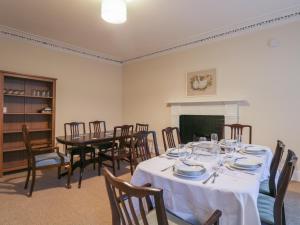a dining room with a table and chairs at Kinnaird House in Grantown on Spey