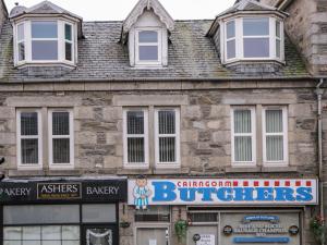 an old building with a sign in front of it at Kinnaird House in Grantown on Spey