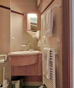 a small bathroom with a sink and a mirror at Pension Fellis in Vols am Schlern