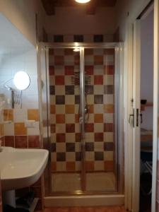 a bathroom with a shower and a sink at B&B PompeiLog in Pompei