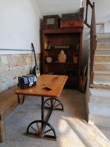 a wooden table in a room with a shelf at Le Mat Hostel in Larnaca