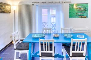 a blue dining room table with chairs and a blue table at IVANA Apartment in Levanto