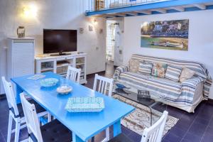 a living room with a blue table and a couch at IVANA Apartment in Levanto