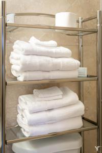 a stack of towels on a rack in a bathroom at P8G Remodel 2BR/2BA downtown ATL-Parking & Balcony in Atlanta