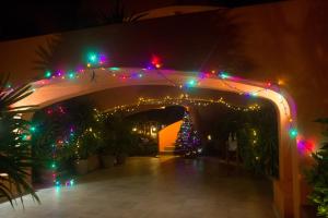 a christmas arch with christmas lights and a christmas tree at La Ceiba del Mar in Zihuatanejo