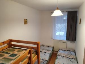 A bed or beds in a room at Apartments Michalka - ap. dom Skalka