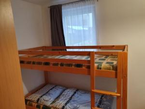 A bed or beds in a room at Apartments Michalka - ap. dom Skalka