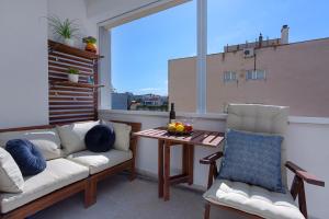 balcón con sofá, mesa y ventana en Deluxe City Center Blue apartment, en Split