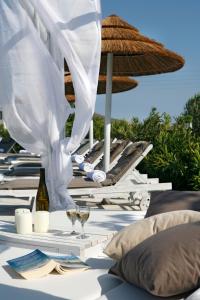 
a white table topped with white umbrellas at Anthea Hotel in Tinos Town
