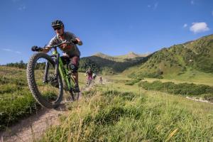 a man riding a bike on a dirt trail at Hotel Dischma in Davos