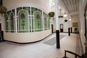 a hallway with a wall of windows in a building at Beautiful City Centre Apartment in Liverpool