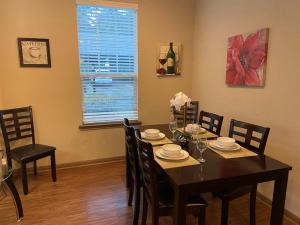 a dining room with a table and chairs and a window at Resort Style Apartment/Home - The Woodlands in The Woodlands