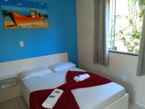 a bedroom with a bed with two towels on it at Pousada Camping Bombinhas in Bombinhas +79 photos