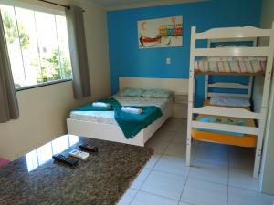 a bedroom with two bunk beds and a ladder at Pousada Camping Bombinhas in Bombinhas