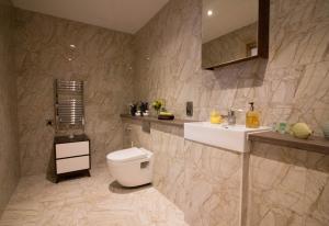 a bathroom with a toilet and a sink at Beautiful City Centre Apartment in Liverpool
