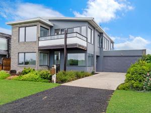 a large house with a driveway in front of it at Stone and Sea in Port Fairy