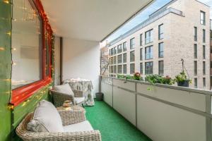 a balcony with chairs and a table and a building at ***UPSCALE***CITY CENTER* in Oslo