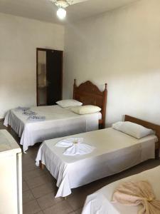 Säng eller sängar i ett rum på Pousada Pantanal