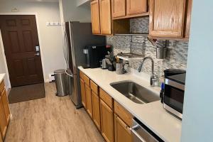 a kitchen with a sink and a refrigerator at Very Spacious apartment close to Lions Head Gondola in Vail