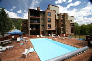 a pool on a deck next to a building at Very Spacious apartment close to Lions Head Gondola in Vail