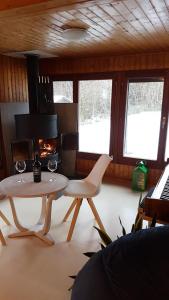 a living room with a table and a fire place at Maison Chalet in Grandfontaine
