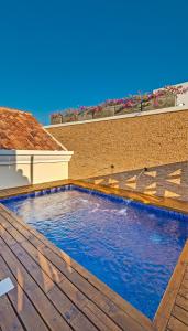 a swimming pool on the deck of a house at Lunalá Hotel Boutique in Cartagena de Indias