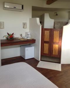 a bedroom with a bed and a counter in a room at Casa Flor de Mar in Zipolite