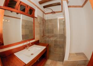 a bathroom with a sink and a shower at Hotel Marquesa de Pinares in Tibasosa