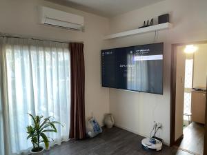 a living room with a large window and a flat screen tv at 次郎の家 in Fuefuki