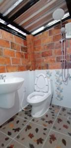 a bathroom with a toilet and a sink at Sun smile(cafe & homestay) in Ubon Ratchathani +80 photos