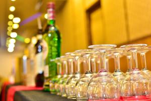 a row of wine glasses sitting on a table at Hotel Blue Sky in Kurunegala