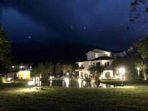 a house at night with lights in the yard at Tree Lake B&B Hualien in Shuhu