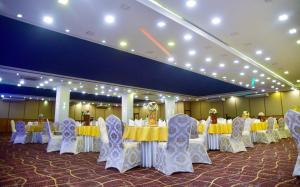 a banquet hall with tables and chairs in a room at Hotel Blue Sky in Kurunegala