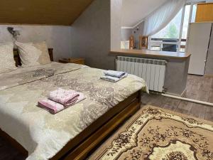 a bedroom with a bed with two towels on it at Maria in Solochyn