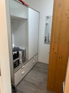 a room with a closet with a glass cabinet at Hahnenklee Ferienpark 409 & 211 in Goslar +32 photos