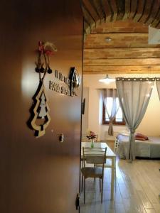 a room with a table and a bedroom with a bed at Il Loft nel Borgo Sospeso "con vista panoramica" in Vitorchiano