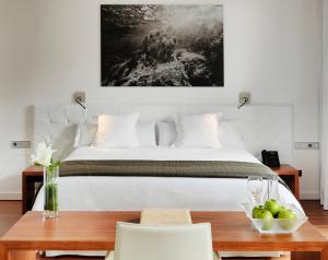 a bedroom with a large bed with a table and chairs at Iberostar Heritage Grand Mencey in Santa Cruz de Tenerife