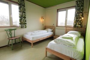 2 camas en una habitación con 2 ventanas en Amsterdam Farm Lodge en Ámsterdam