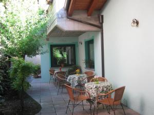 an outdoor patio with tables and chairs in a building at Albergo Sangalli in Boario Terme