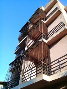 a building with fire escapes on the side of it at Belle-Vue Holiday Homes in Panchgani