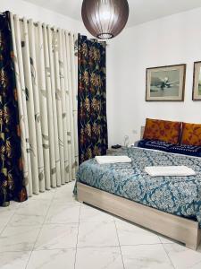 a bedroom with a bed and some curtains at CASA DEI FIORI in Somma Lombardo