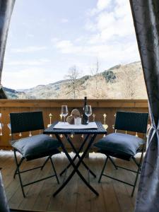 a table and chairs on a balcony with a view at Haus Holzer in Wagrain