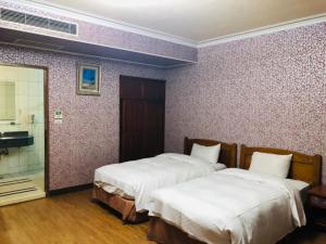 Postel nebo postele na pokoji v ubytování 巨地花園莊園