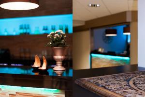 a dining room with a vase with flowers on a table at Hotel Expo Stockholm in Stockholm