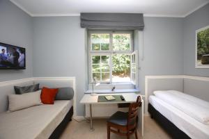 Postel nebo postele na pokoji v ubytování Jugendstilhotel Trifels