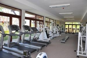 a gym with rows of tread machines and windows at la caze de sosomais seychelles in Mahe