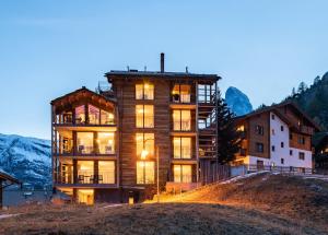 a large building on top of a hill at 22 Summits Apartments in Zermatt