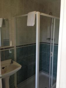 a bathroom with a shower and a sink at Berties Lodge in Newquay